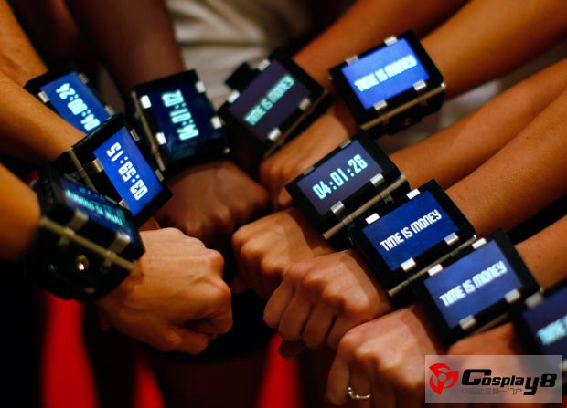 Models pose for a picture wearing wrist watches to promote the upcoming motion picture In Time