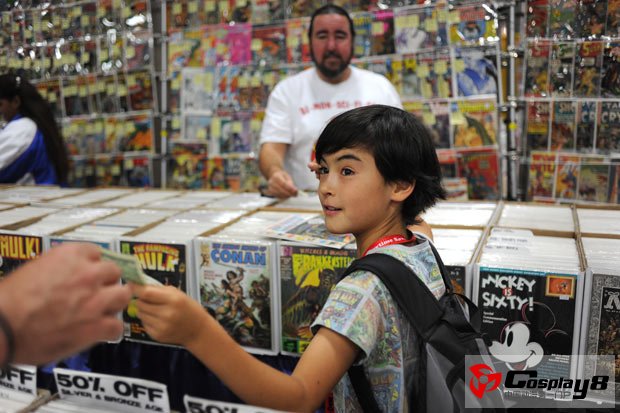 Cameron Addis, 10, turns to his father for some money to purchase a comic book
